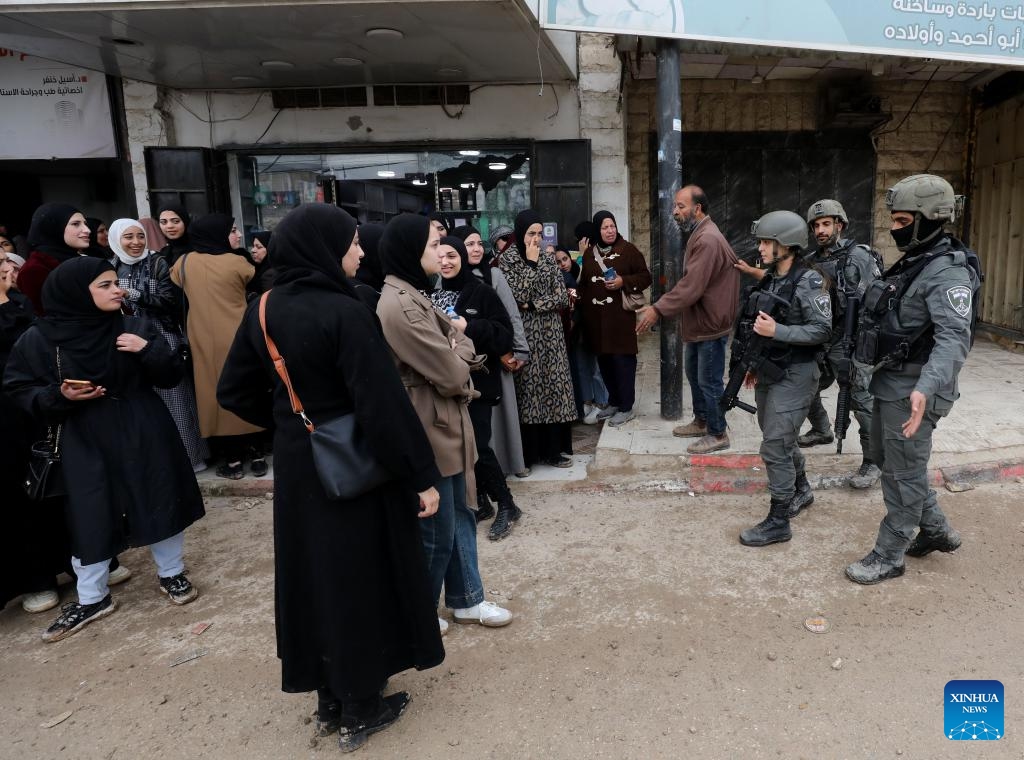 Israeli border police prevent displaced Palestinians in the West Bank city of Jenin from getting back to their houses in the Jenin refugee camp, on Feb. 19, 2025. Palestine on Wednesday accused Israel of waging a comprehensive war on the West Bank, particularly in the northern regions, involving crimes of murder, displacement, and the destruction of property. (Photo: Xinhua)