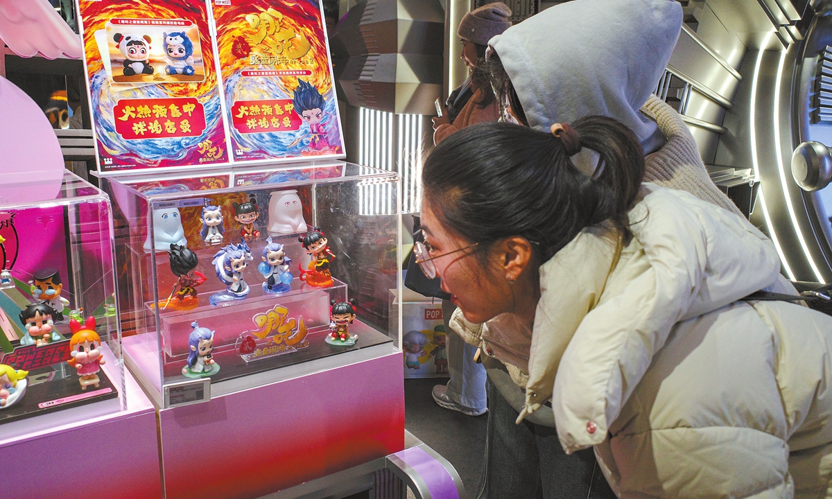 Shoppers explore the <em>Ne Zha 2</em>blind box toys at the global flagship store of Pop Mart in East China's Shanghai on February 17, 2025. 