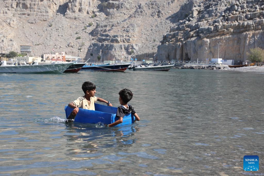 Children enjoy themselves in the water at Kumzar Village in Oman, Feb. 19, 2025. Kumzar, a remote fishing village in the Musandam Peninsula in northern Oman, located in a sheltered harbor near the strategic shipping lane of the Strait of Hormuz. Due to its unique geographical location, Kumzar can only be accessed by boat, making it relatively isolated from the rest of Oman. This isolation has helped preserve its distinct cultural and linguistic identity. The residents of Kumzar primarily rely on fishing for their livelihood, maintaining a traditional maritime way of life. (Photo: Xinhua)