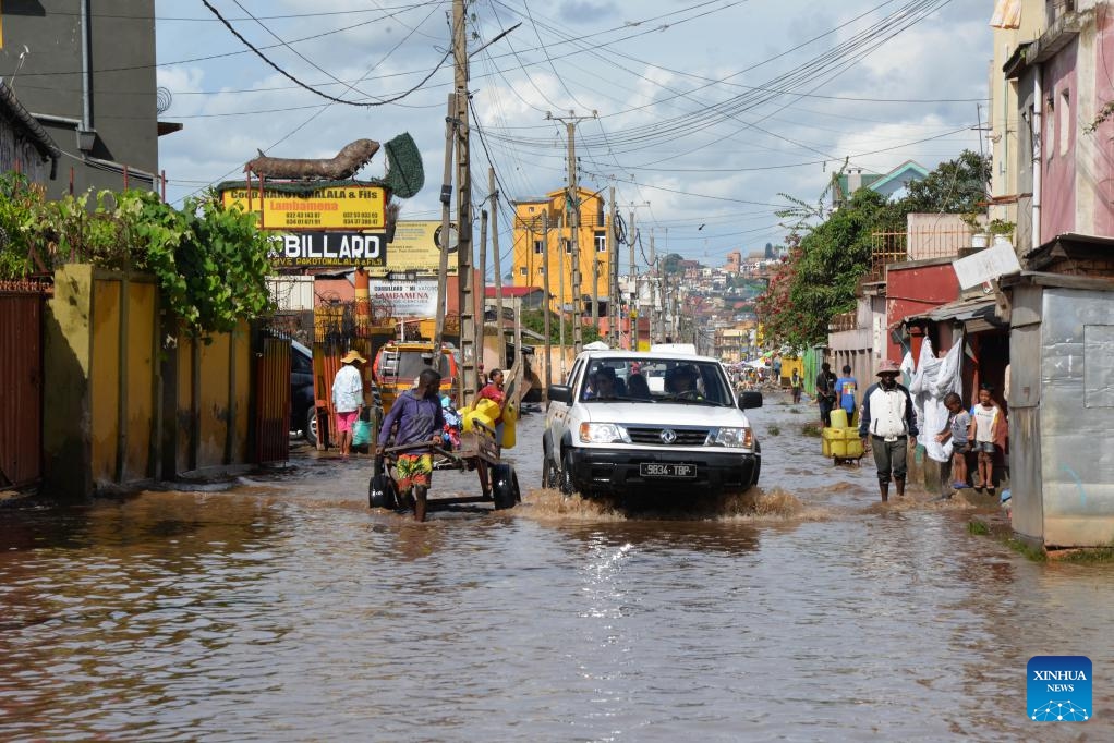 Residents move through a flooded road in Antananarivo, Madagascar, Feb. 20, 2025. The death toll from the heavy rains that have hit Madagascar since Feb. 14 rose to 11, according to the latest report from the National Office for Risk and Disaster Management (BNGRC) released on Thursday. (Photo: Xinhua)