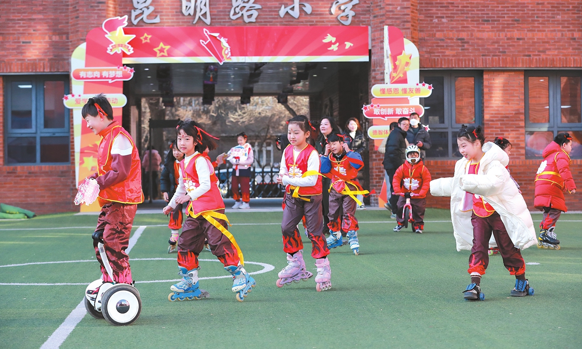 Students dressed as Ne Zha glide on roller skates to greet their classmates during the opening of the spring semester at a primary school in the Tianjin Municipality in North China on February 17, 2025. 