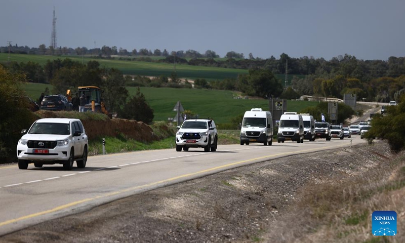 A convoy carrying the bodies of Israeli hostages is pictured on a road in southern Israel on Feb. 20, 2025. Palestinian armed groups on Thursday morning handed over the bodies of four Israeli hostages killed in the Gaza Strip during the Israeli war to the International Committee of the Red Cross (ICRC) team, Palestinian sources said. (Photo: Xinhua)