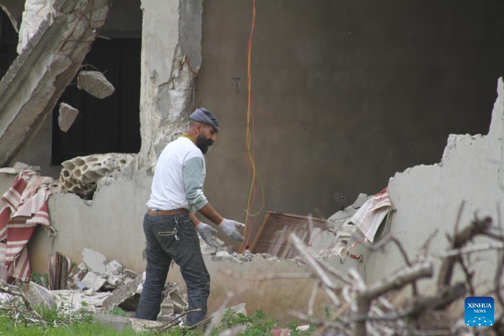 A man returns to his destroyed home in Wazzani, Lebanon, on Feb. 19, 2025. The Israeli army withdrew from border areas of southern Lebanon on Tuesday but remained in five positions, an Israeli official said, despite the expiration of the deadline for a full withdrawal under a ceasefire agreement with Hezbollah. (Photo: Xinhua)