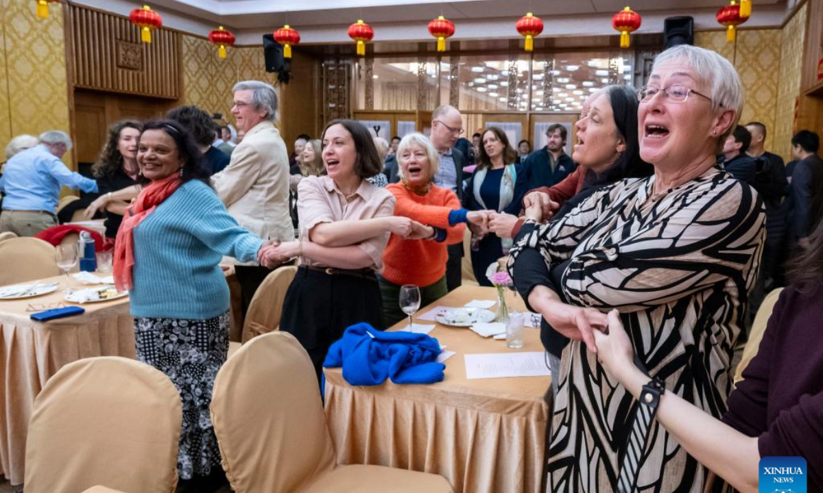 Guests hold hands and sing Auld Lang Syne at a reception for the families of the Lisbon Maru survivors in London, Britain, on Feb. 22, 2025.

The Chinese Embassy in the United Kingdom hosted a special reception in London on Saturday for the families of the Lisbon Maru survivors, commemorating the heroic rescue during World War II and celebrating the Spring Festival. (Photo by Stephen Chung/Xinhua)