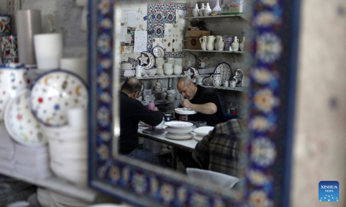 Palestinian workers make ceramic handicrafts at a shop in the West Bank city of Hebron, on Feb. 26, 2025. (Photo by Mamoun Wazwaz/Xinhua)