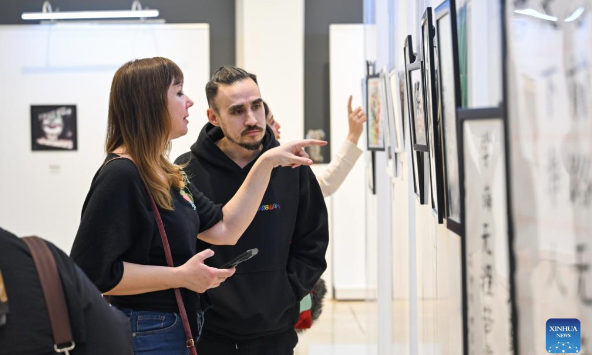 People visit an international art exhibition in Istanbul, Türkiye, on Feb. 24, 2025. The international art exhibition opened in Istanbul on Monday, highlighting the cultural connections among China, Türkiye, and other nations along the Silk Road. (Xinhua/Liu Lei)