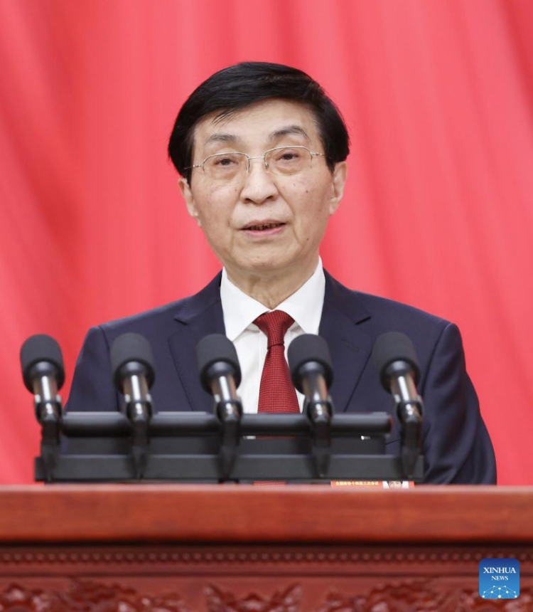 Wang Huning, chairman of the Chinese People's Political Consultative Conference (CPPCC) National Committee, delivers a work report on behalf of the Standing Committee of the CPPCC National Committee at the opening meeting of the third session of the 14th CPPCC National Committee at the Great Hall of the People in Beijing, capital of China, March 4, 2025. (Xinhua/Liu Weibing)