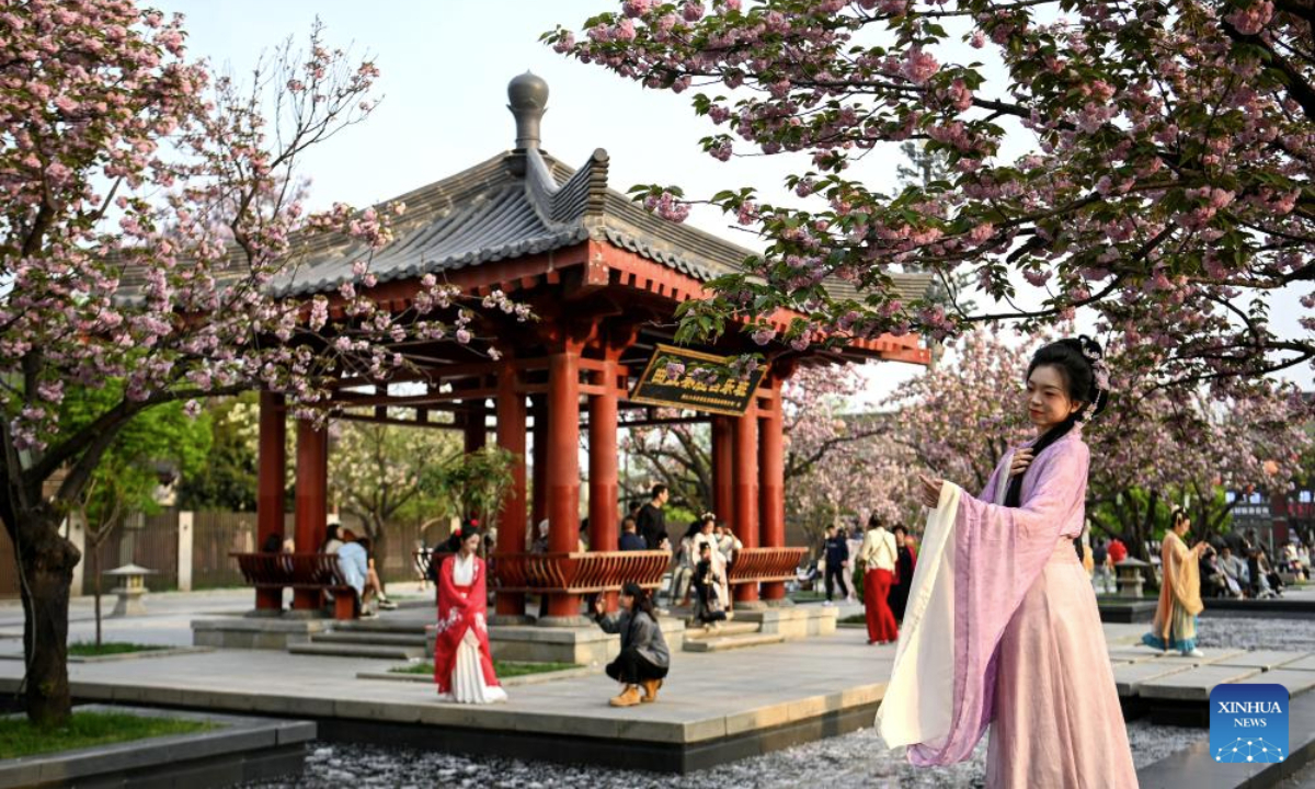 Tourists admire blossoms and pose for photos in the Giant Wild Goose Pagoda scenic area in Xi'an, northwest China's Shaanxi Province, April 8, 2024. As the provincial capital of northwest China's Shaanxi Province, Xi'an, with a history of over 3,100 years, has served as the capital city for 13 dynasties of China. Under the policies of protection and utilization of cultural relics, the historical and cultural resources of Xi'an have been well preserved. (Xinhua/Zou Jingyi)