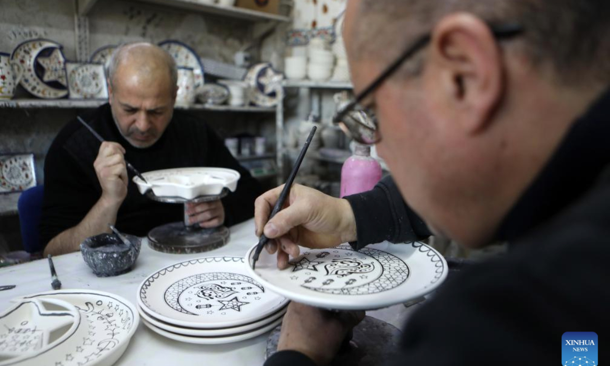 Palestinian workers make ceramic handicrafts at a shop in the West Bank city of Hebron, on Feb. 26, 2025. (Photo by Mamoun Wazwaz/Xinhua)