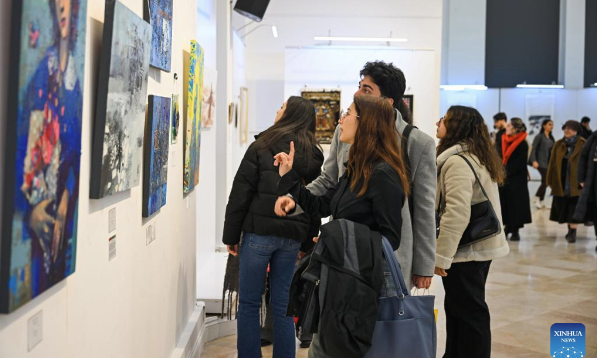 People visit an international art exhibition in Istanbul, Türkiye, on Feb. 24, 2025. The international art exhibition opened in Istanbul on Monday, highlighting the cultural connections among China, Türkiye, and other nations along the Silk Road. (Xinhua/Liu Lei)