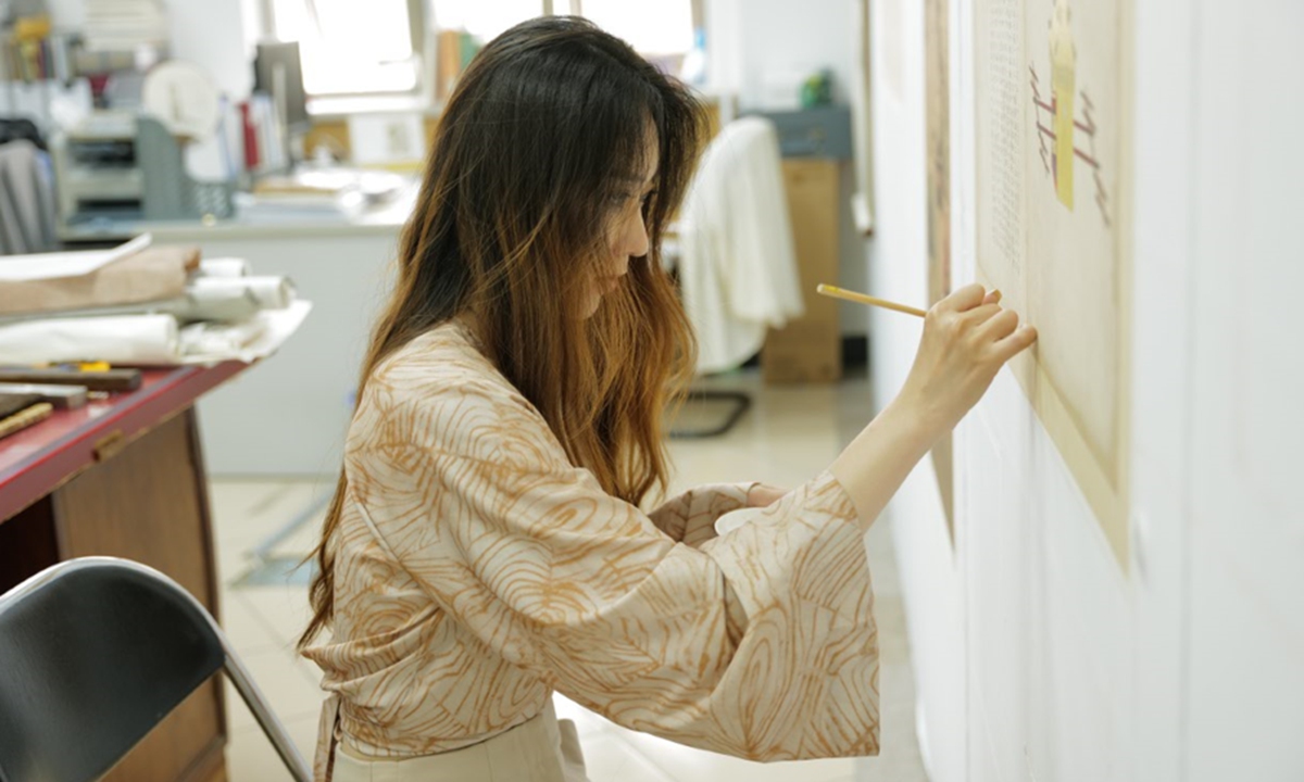 An expert works on the restoration of an ancient book at the Capital Library of China.  Photo: Courtesy of Capital Library 