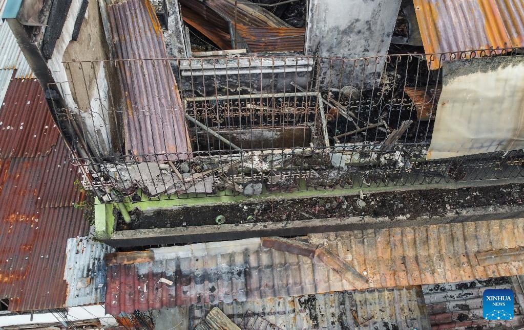 An aerial photo shows the site of a fire accident in Quezon City, the Philippines, Feb. 27, 2025. Eight people were killed after a fire razed a three-storey residential building in the Philippine capital on Thursday, the Bureau of Fire Protection said. The bureau said the fire broke out early Thursday morning in Quezon City suburb while the occupants were fast asleep. (Photo: Xinhua)