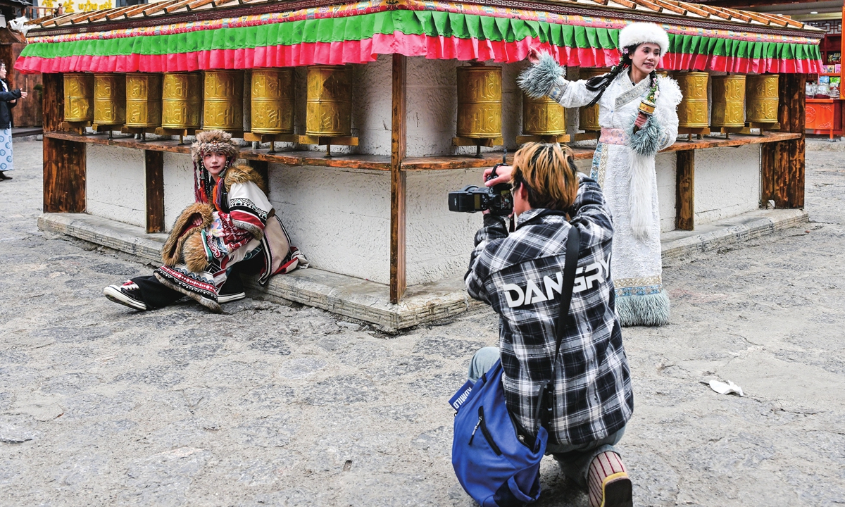 Tourists in ethnic costumes have pictures taken in the ancient town of Dukezong, Southwest China's Yunnan Province, on March 1, 2025. Photo: VCG