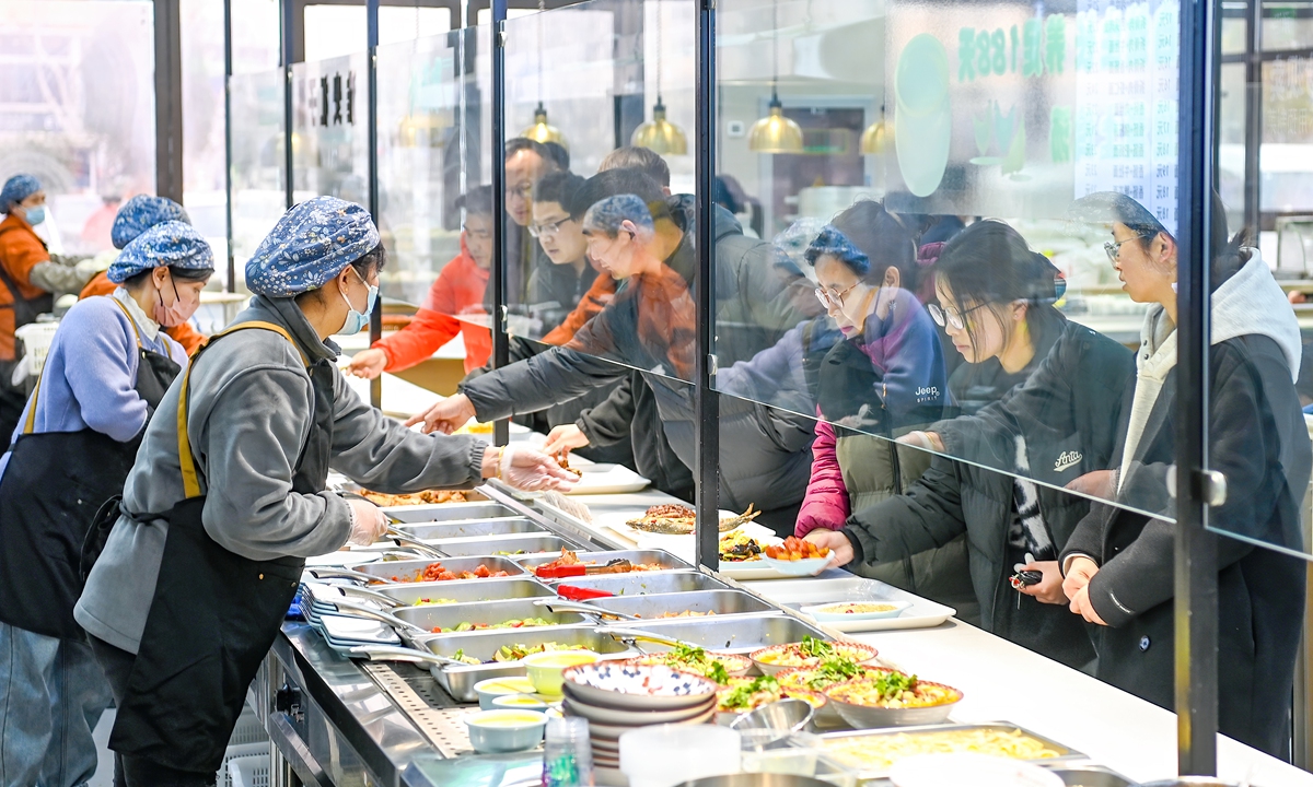 Residents line up to get meals in a senior canteen located in the Suqian Economic and Technological Development Zone, Jiangsu Province, on March 4, 2025. Photo:VCG