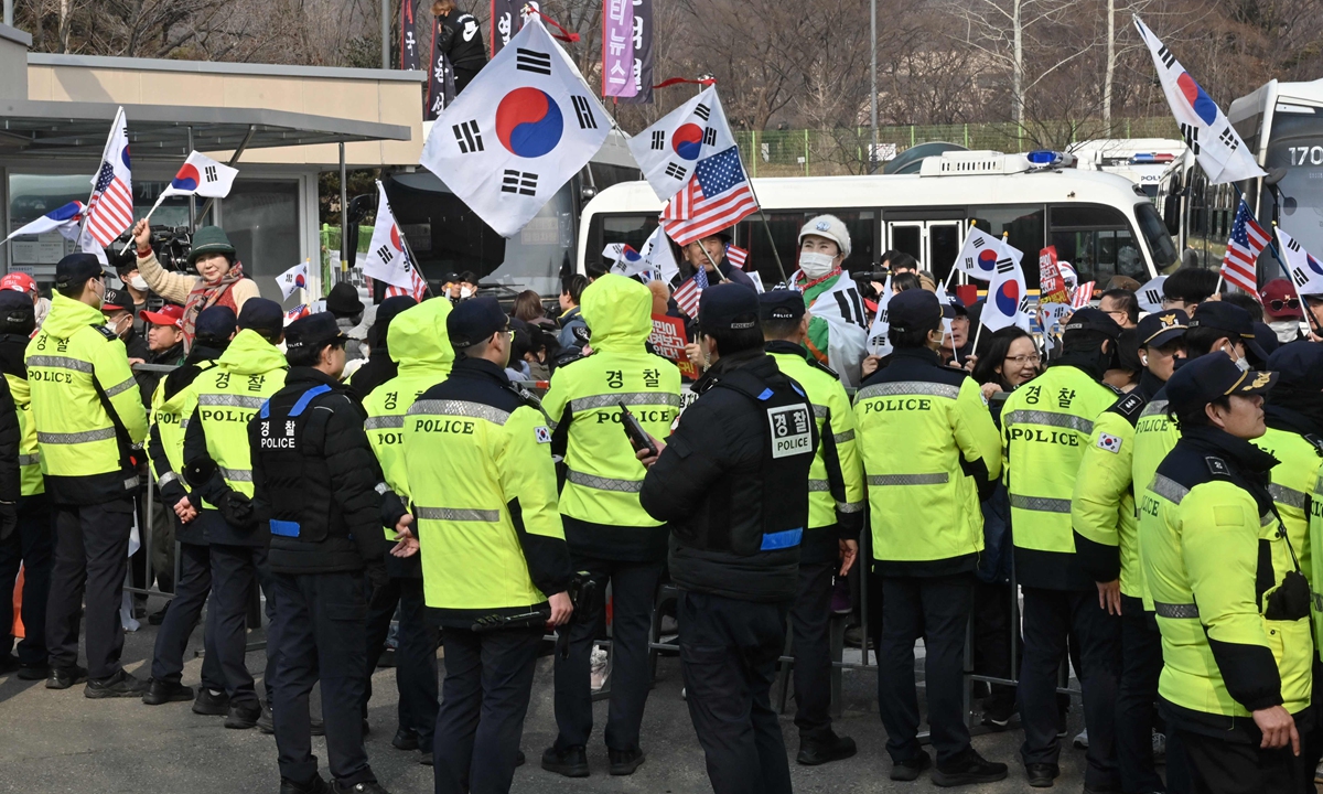 Des partisans du président sud-coréen Yoon Suk-yeol, arrêté et destitué, agitent les drapeaux nationaux alors qu’ils se rassemblent devant le centre de détention de Séoul à Uiwang, en Corée du Sud, le 7 mars 2025. Crédit photo : VCG