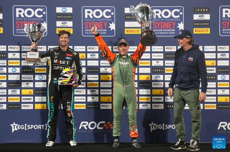 Winner Sebastien Loeb (C) of France and runner-up Chaz Mostert (L) of Australia hold the trophies during the awarding ceremony for the Race of Champions (ROC) at Accor Stadium in Sydney, Australia, March 8, 2025. Photo: Xinhua